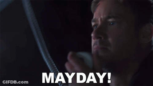 Man In Dark Room With Mayday On Face GIF