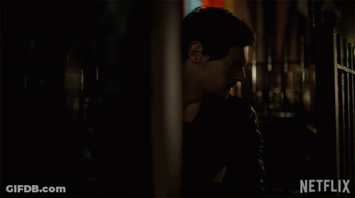 Man In Dark Room With Netflix Logo GIF