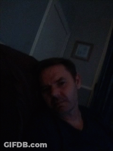Man In Dark Room With Picture GIF