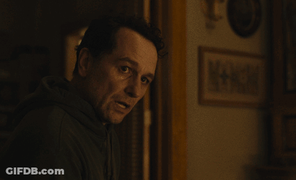 Man In Dark Room With Picture Saying A + GIF