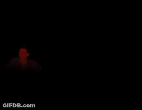 Man In Dark Room With Red Light GIF