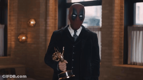 Man In Deadpool Mask Holding Trophy GIF