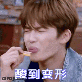 Man In Denim Jacket Eating With Chinese Writing Behind Him GIF