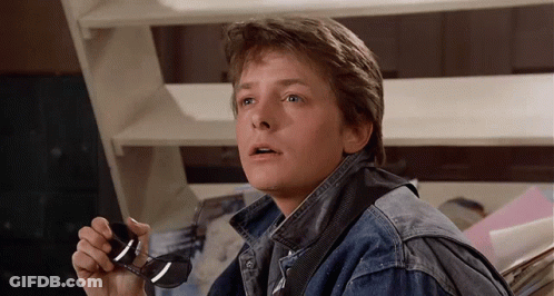 Man In Denim Jacket Holding Sunglasses GIF