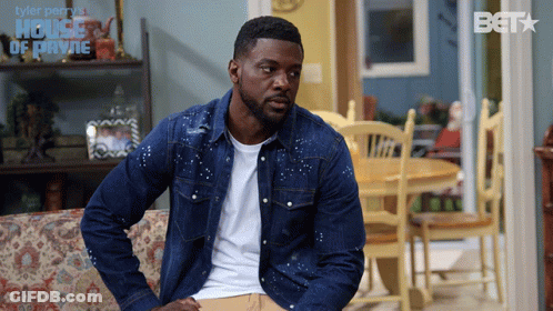 Man In Denim Jacket In Front Of House Of Payne Sign GIF