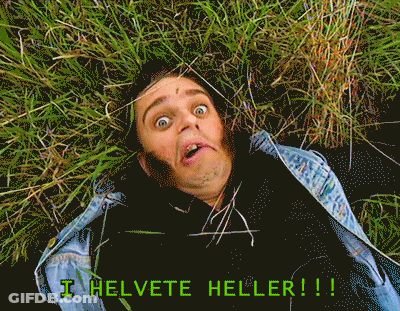 Man In Denim Jacket Laying In Grass With I Helvete Heller GIF