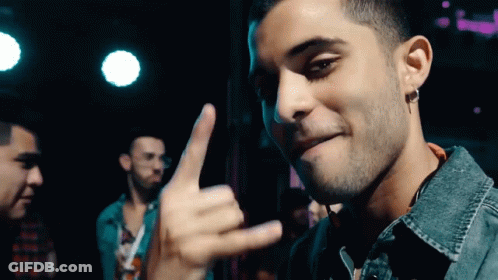 Man In Denim Jacket Making Hand Gesture GIF