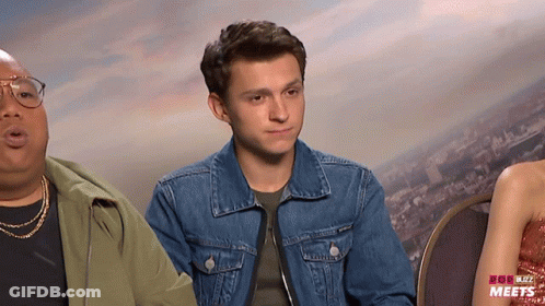 Man In Denim Jacket Next To Woman In Red Dress GIF