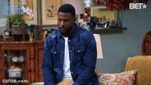 Man In Denim Jacket On Couch With BET Logo GIF