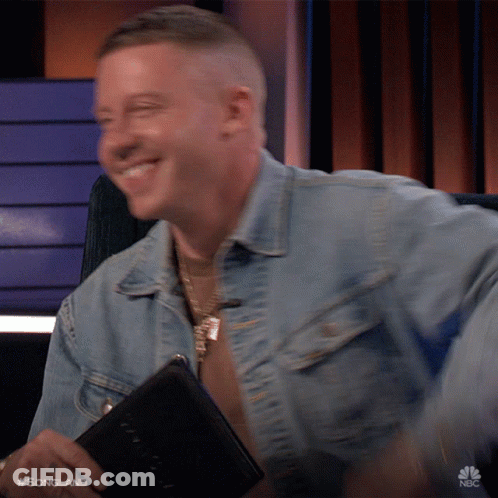 Man In Denim Jacket Smiling Holding Book With Songland GIF
