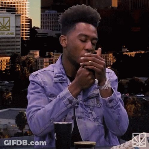 Man In Denim Jacket Smoking Cigarette GIF