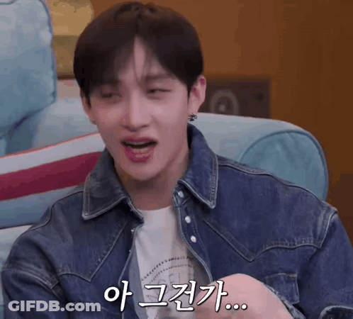 Man In Denim Jacket With Foreign Text On Face GIF