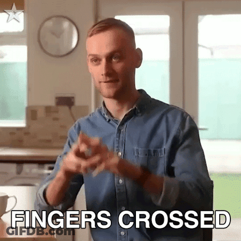 Man In Denim Shirt Crosses Fingers GIF