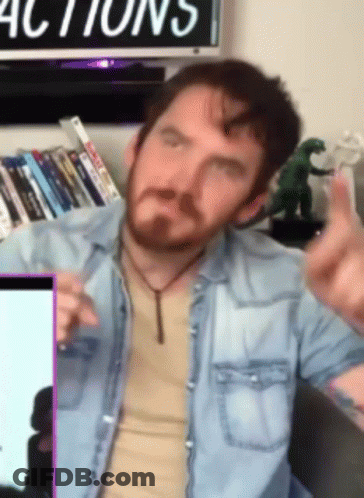 Man In Denim Shirt Giving Middle Finger In Front Of Actions Sign GIF
