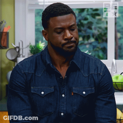 Man In Denim Shirt Looking Down GIF