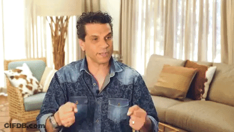 Man In Denim Shirt Sitting By Couch GIF