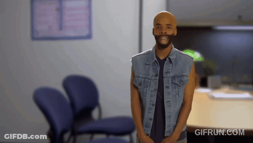 Man In Denim Vest Standing In Waiting Room GIF