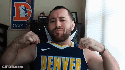 Man In Denver Jersey Flexing Muscles In Front Of Broncos Poster GIF