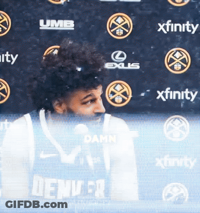 Man In Denver Jersey In Front Of Xfinity Banner GIF