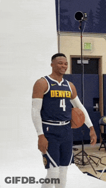 Man In Denver Jersey Number 4 Holding Basketball GIF