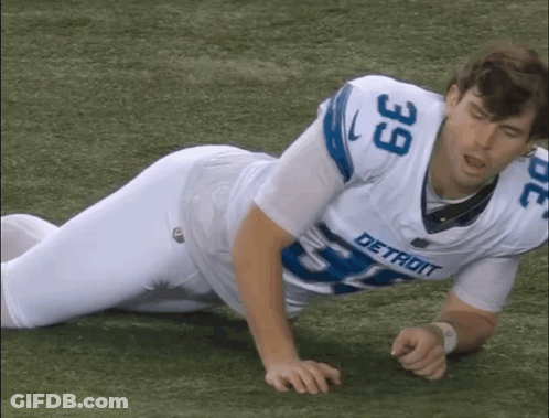 Man In Detroit Jersey Laying On Grass GIF