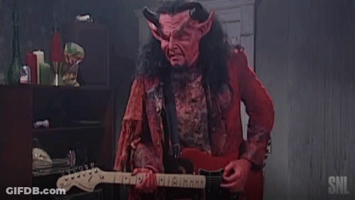 Man In Devil Costume Playing Guitar With SNL Logo GIF