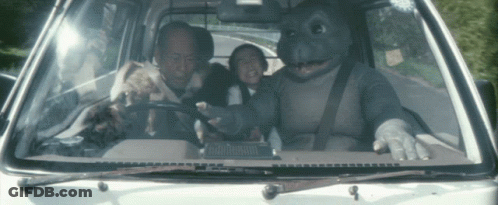 Man In Dinosaur Costume Driving Car With Two Kids GIF