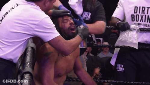 Man In Dirt Boxing Shirt Helping Man In Ring GIF