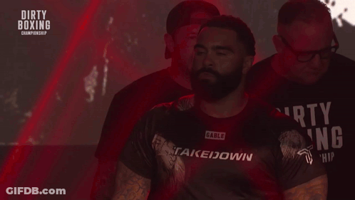 Man In Dirty Boxing Shirt Walking Down Stairs GIF