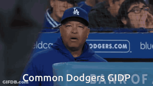 Man In Dodgers Hat In Front Of Common Dodgers Sign GIF