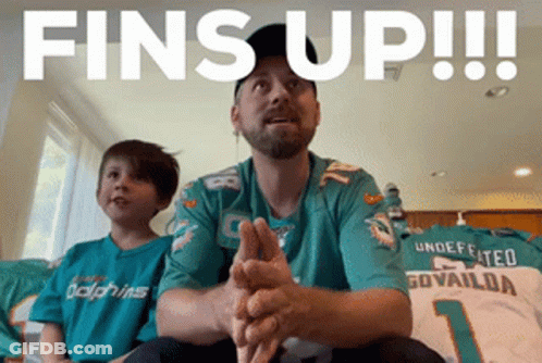 Man In Dolphins Jersey Sitting Next To Boy GIF