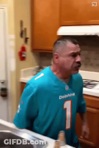 Man In Dolphins Jersey Standing In Kitchen GIF