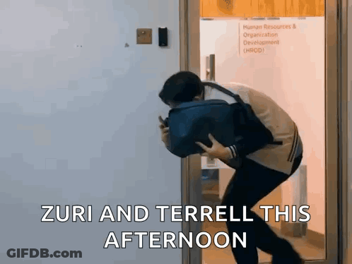 Man In Doorway Holding Bag And Phone GIF