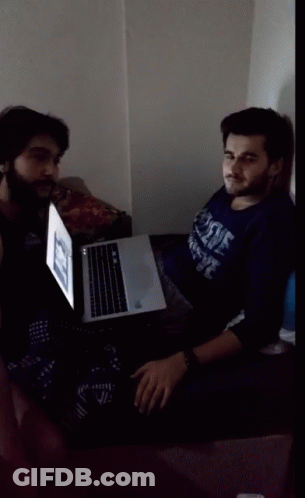 Man In Duke Shirt Sitting In Front Of Laptop GIF
