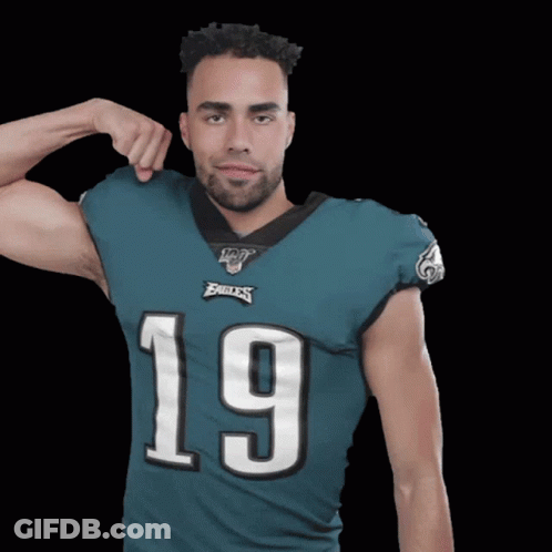 Man In Eagles Jersey Flexing Arm GIF