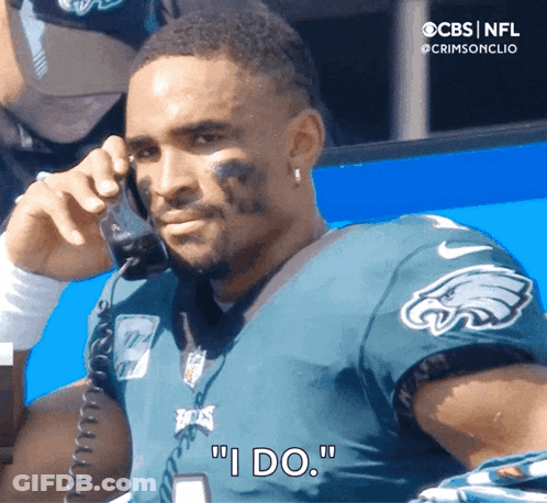 Man In Eagles Jersey Saying I Do On Phone GIF