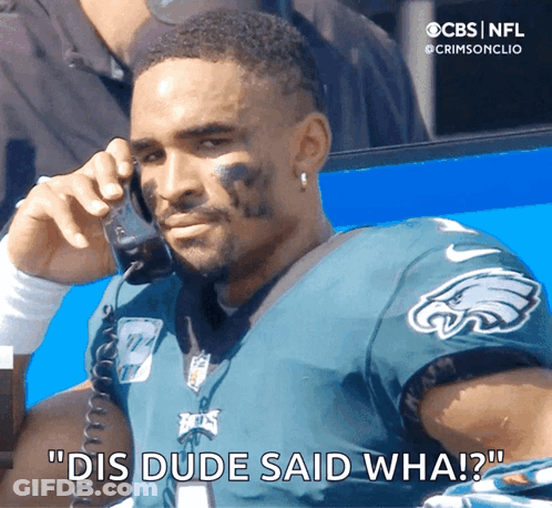 Man In Eagles Jersey Talking On Phone GIF