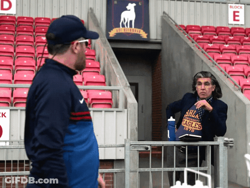 Man In Eagles Shirt Talking In Stadium GIF