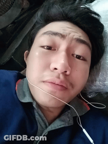Man In Ear Buds Laying Down Looking GIF