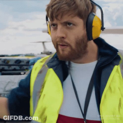 Man In Ear Muffs Yellow Vest Near Airplane GIF