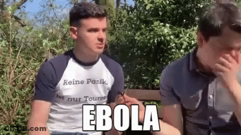 Man In Ebola Shirt Next To Another Man GIF