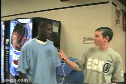 Man In Ecko Shirt Being Interviewed GIF