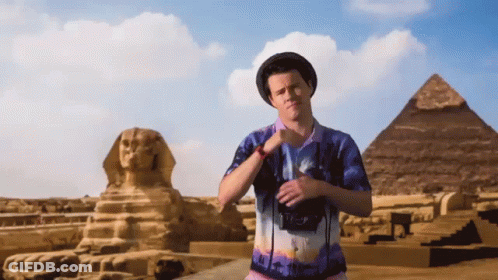 Man In Egypt Shirt In Front Of Pyramid GIF