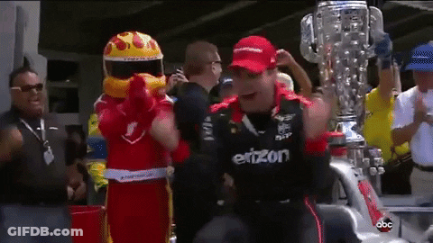 Man In Einzon Shirt Standing Before Trophy GIF