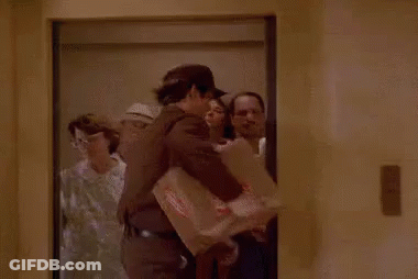 Man In Elevator Holding Box With Priority Mail Sticker GIF