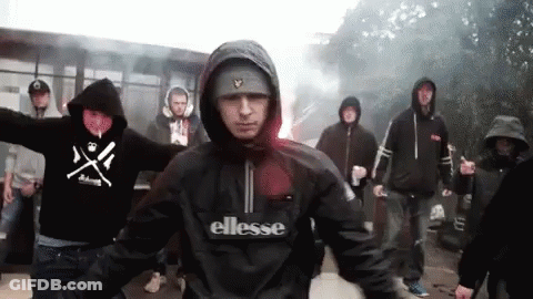 Man In Ellesse Jacket Standing In Front Of Group GIF
