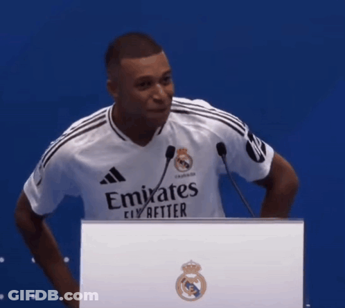 Man In Emirates Shirt Behind Podium GIF