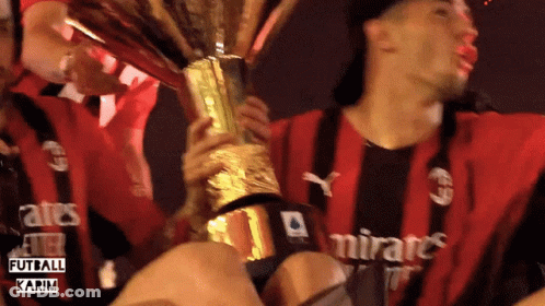 Man In Emirates Shirt Holding Trophy GIF