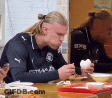 Man In Etihad Shirt At Table With Bowls Of Food GIF