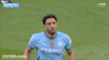 Man In Etihad Shirt Kneeling On Grass GIF